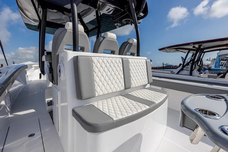 Slide: The Image of 2026 Front Runner 39 Center Console storage compartment with tackle boxes and speakers. - 22