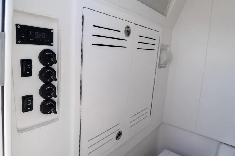 Slide: The Image of Control panel of 2026 Front Runner 39 Center Console boat, featuring switches and digital display. - 33