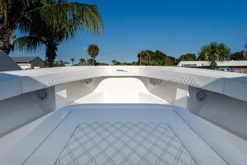 Slide: The Image of 2026 Front Runner 39 Center Console boat interior with white seating and palm trees in background. - 36