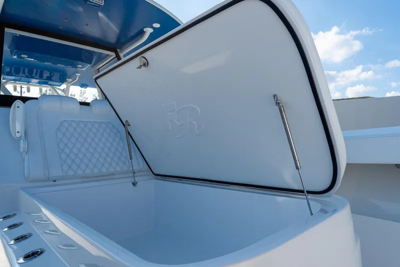 Slide: The Image of 2026 Front Runner 39 Center Console boat with open storage compartment, blue interior accents. - 38