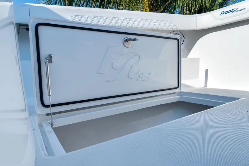 Slide: The Image of 2026 Front Runner 39 Center Console boat storage compartment open under sunny skies. - 41