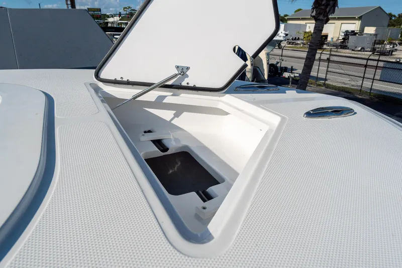 Slide: The Image of Open storage compartment on 2026 Front Runner 39 Center Console boat deck. - 42