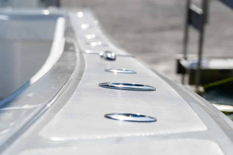 Slide: The Image of Close-up of 2026 Front Runner 39 Center Console boat's sleek metallic surface. - 44