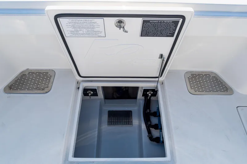 Slide: The Image of Open hatch on 2026 Front Runner 39 Center Console boat deck, showing storage compartment. - 46