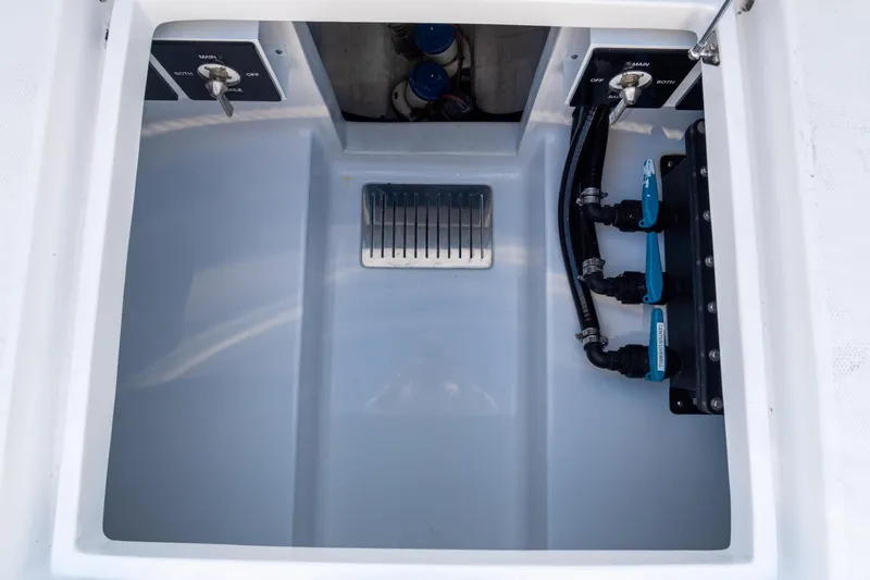 Slide: The Image of 2026 Front Runner 39 Center Console boat compartment with switches and valves. - 47