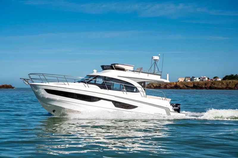 Slide: The Image of 2026 Beneteau Antares 11 Fly cruising on calm waters under a clear blue sky. - 1