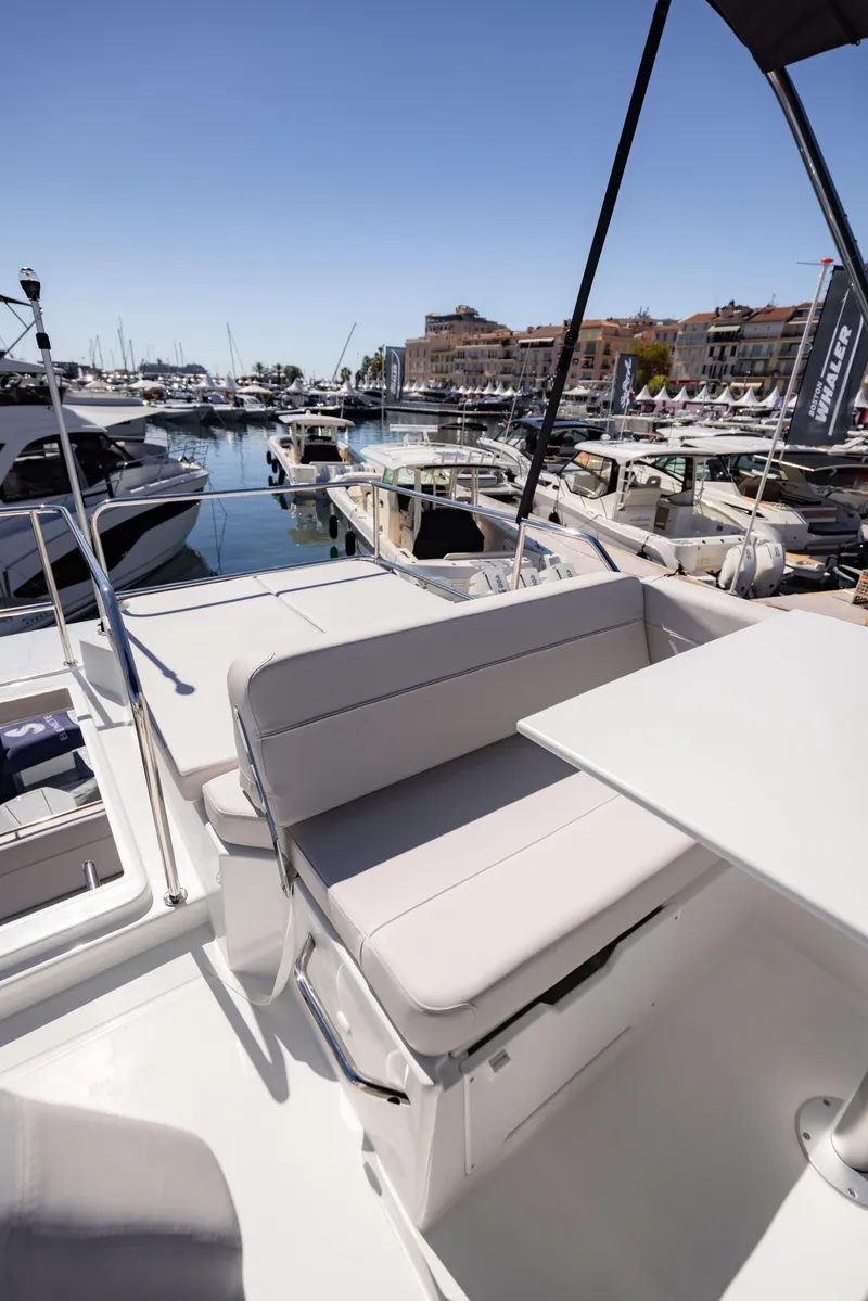 Slide: The Image of 2026 Beneteau Antares 11 Fly yacht with seating area, docked in a marina under clear skies. - 12