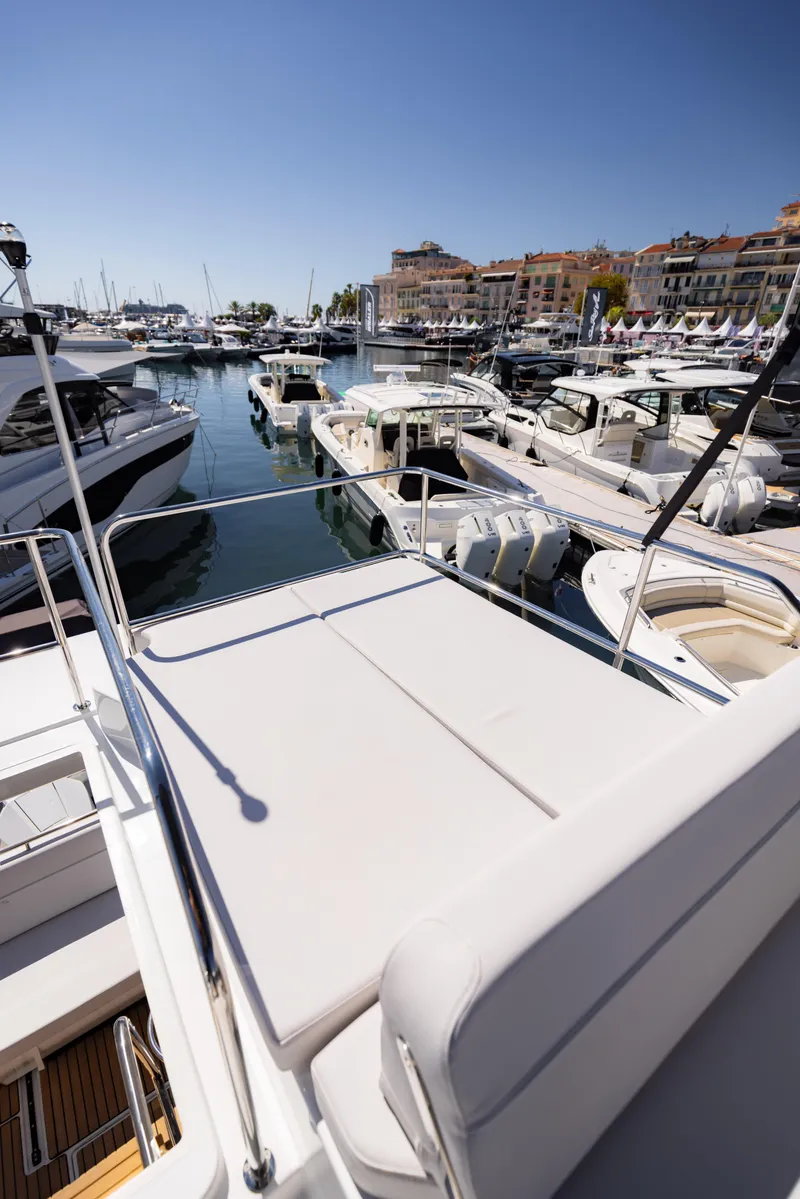 Slide: The Image of 2026 Beneteau Antares 11 Fly yacht docked in a sunny marina. - 14