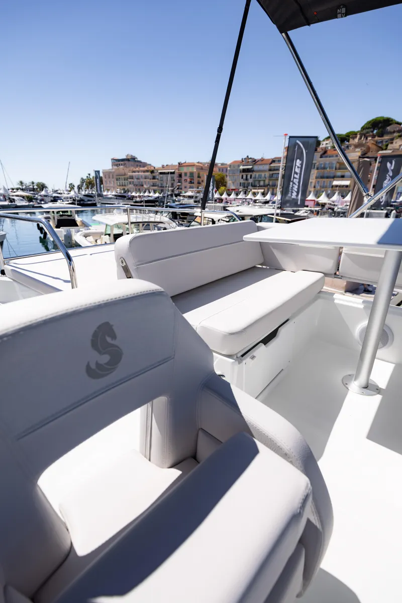 Slide: The Image of 2026 Beneteau Antares 11 Fly yacht interior with marina view, featuring elegant seating. - 15