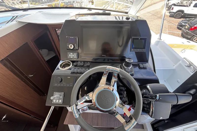 Slide: The Image of Helm of 2026 Beneteau Antares 11 Fly with modern navigation controls and steering wheel. - 17