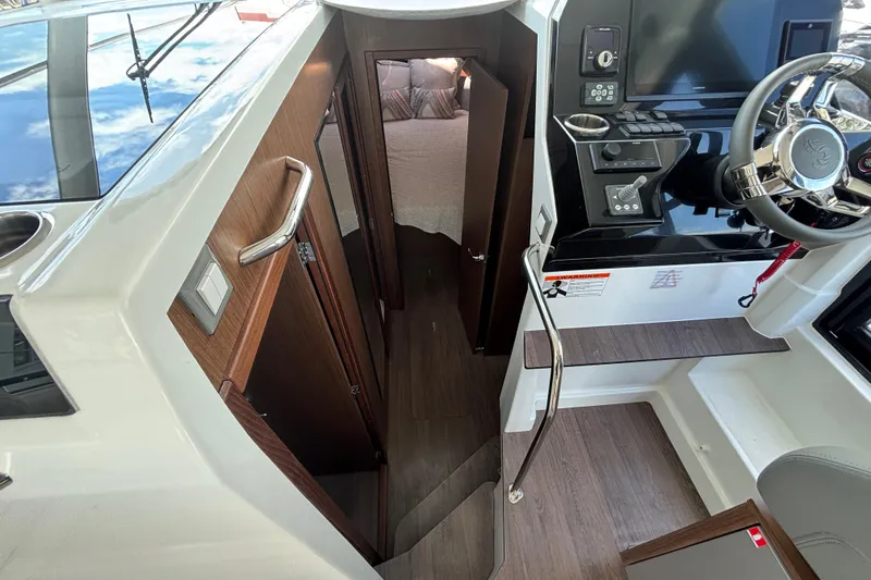 Slide: The Image of Interior view of 2026 Beneteau Antares 11 Fly, featuring helm and cabin entrance. - 18
