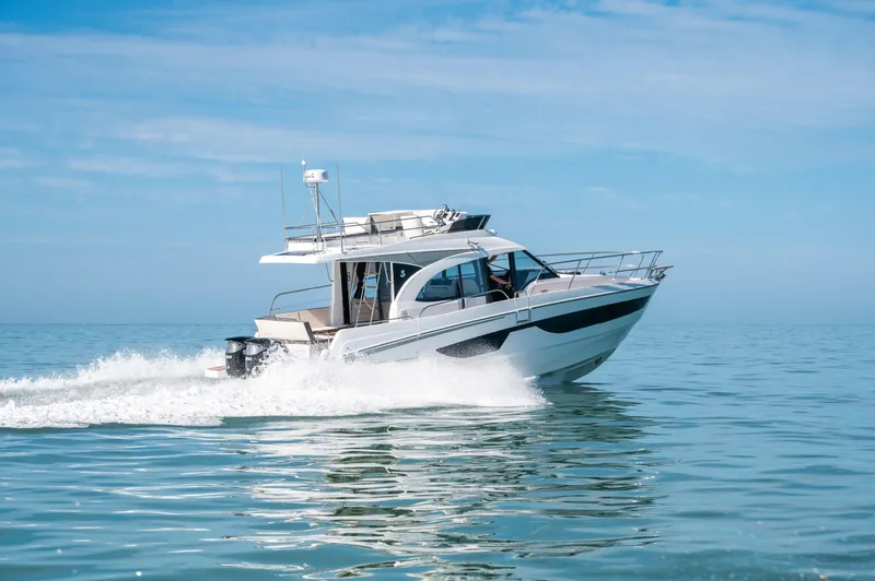 Slide: The Image of 2026 Beneteau Antares 11 Fly cruising on calm blue waters. - 2