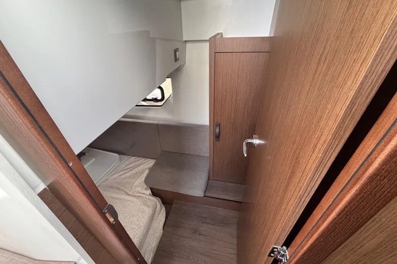 Slide: The Image of 2026 Beneteau Antares 11 Fly cabin interior with wood finish and compact design. - 21