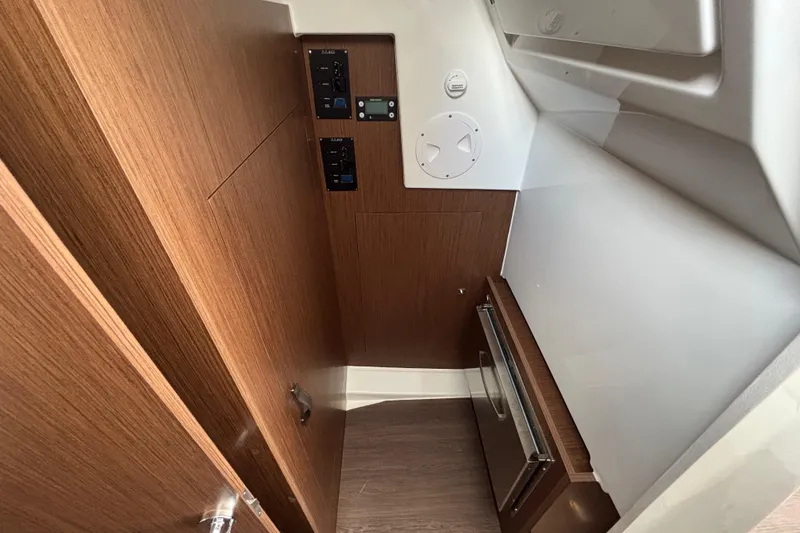 Slide: The Image of 2026 Beneteau Antares 11 Fly interior with wood paneling and control panels. - 23