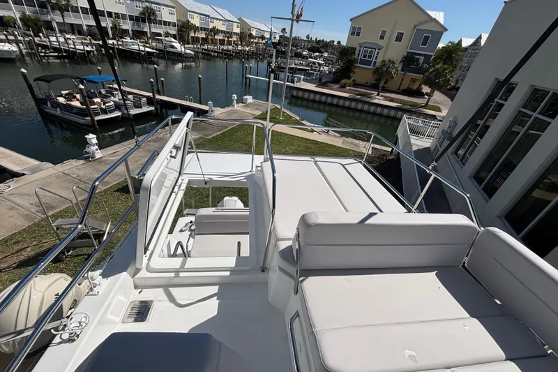 Slide: The Image of 2026 Beneteau Antares 11 Fly yacht at marina, featuring spacious flybridge seating. - 24