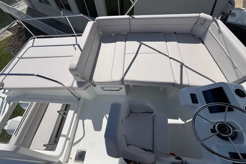 Slide: The Image of 2026 Beneteau Antares 11 Flybridge with cushioned seating and steering wheel. - 25