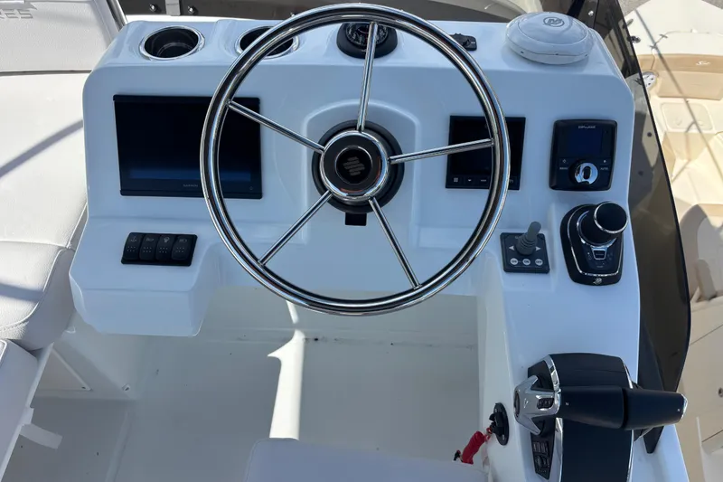 Slide: The Image of 2026 Beneteau Antares 11 Fly helm with steering wheel and navigation controls. - 27