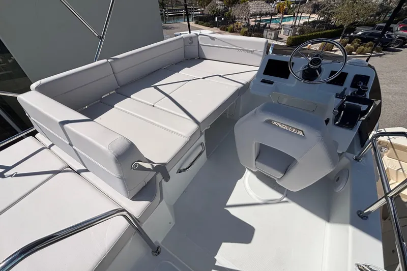 Slide: The Image of 2026 Beneteau Antares 11 Flybridge with helm and seating area, showcasing modern design. - 28
