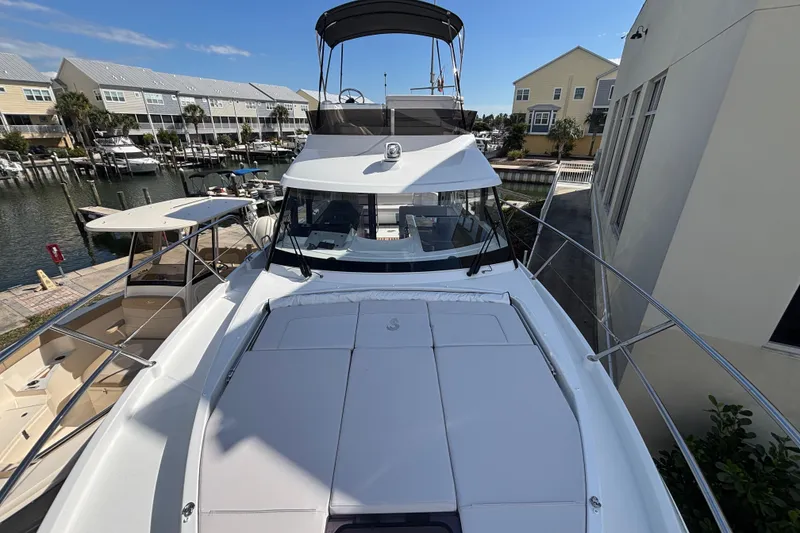 Slide: The Image of 2026 Beneteau Antares 11 Fly yacht docked at a marina, showcasing sleek design. - 32