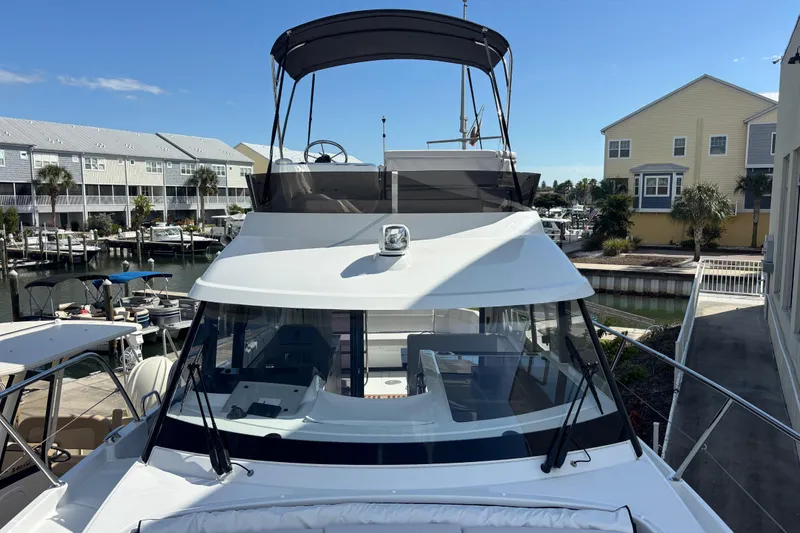 Slide: The Image of 2026 Beneteau Antares 11 Fly yacht docked at marina under clear blue sky. - 33