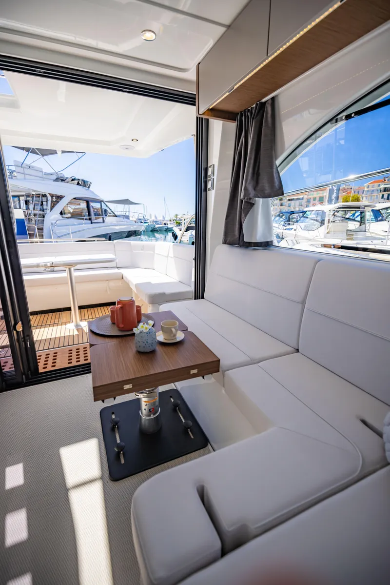 Slide: The Image of Luxurious interior of 2026 Beneteau Antares 11 Fly yacht with elegant seating and table. - 7
