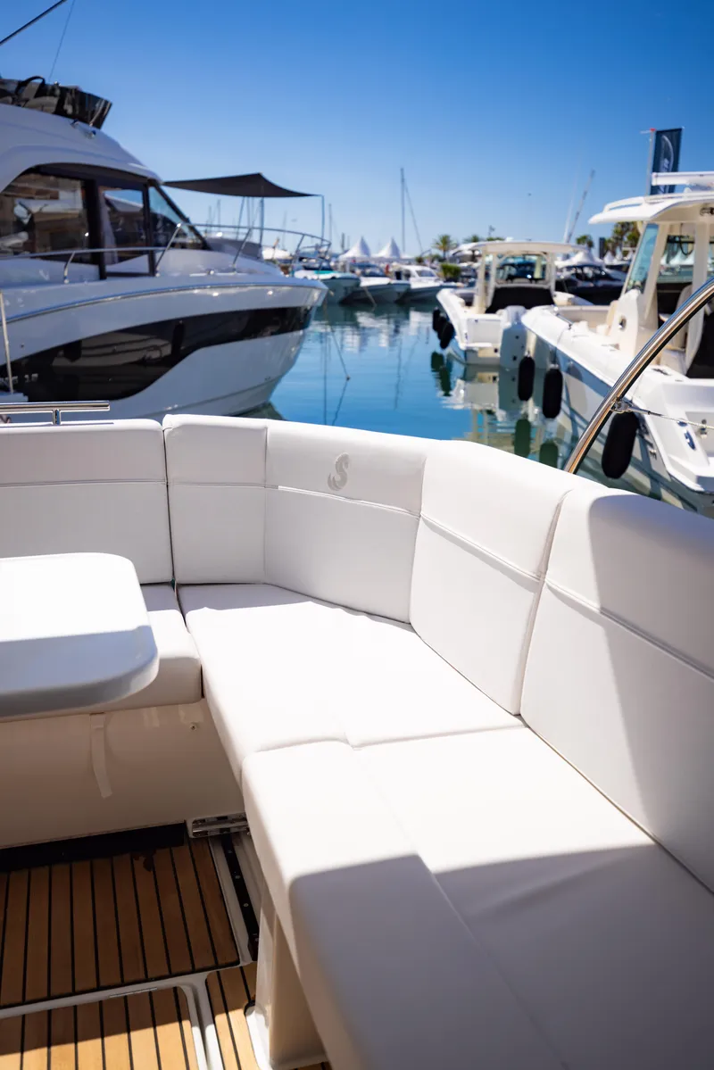 Slide: The Image of 2026 Beneteau Antares 11 Fly yacht with white seating, docked in a marina. - 8