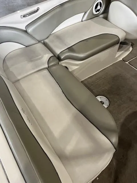 Slide: The Image of 2006 Sea Ray Sundeck 240 interior seating with gray and white upholstery. - 11