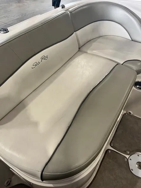Slide: The Image of 2006 Sea Ray Sundeck 240 boat interior seating with beige and gray upholstery. - 12
