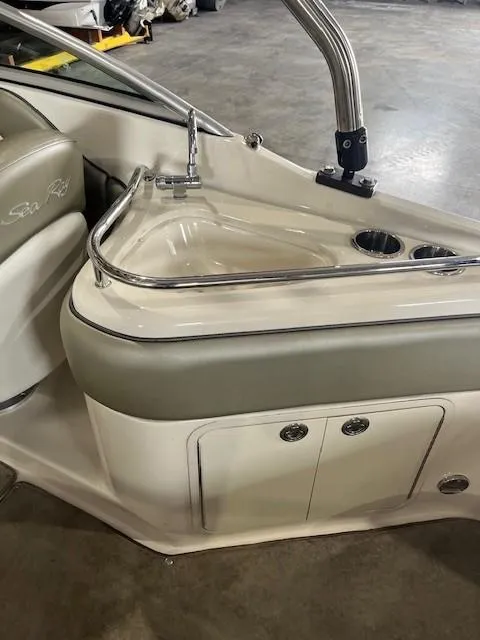Slide: The Image of 2006 Sea Ray Sundeck 240 interior with seating and cup holders. - 13