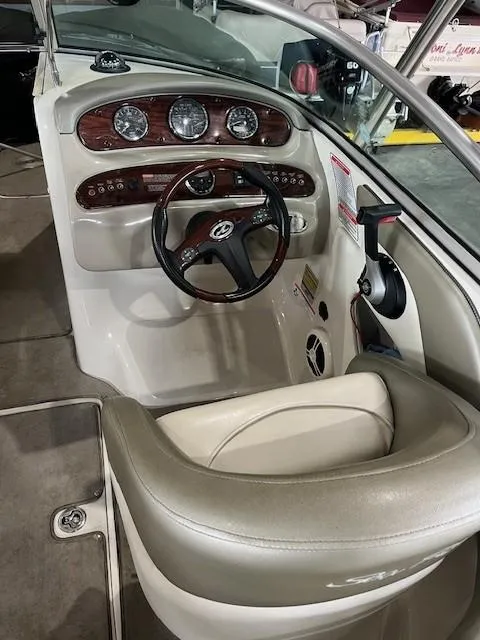 Slide: The Image of 2006 Sea Ray Sundeck 240 boat cockpit with steering wheel and control panel. - 16