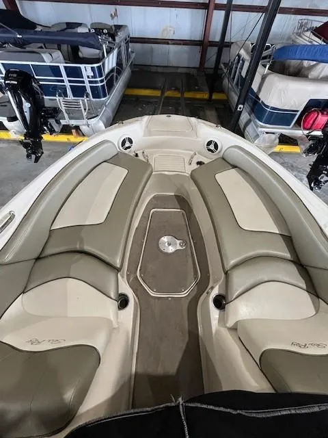 Slide: The Image of 2006 Sea Ray Sundeck 240 with beige seating in storage facility. - 19