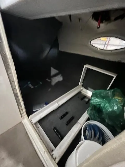 Slide: The Image of Interior of 2006 Sea Ray Sundeck 240 boat with storage area and porthole. - 26