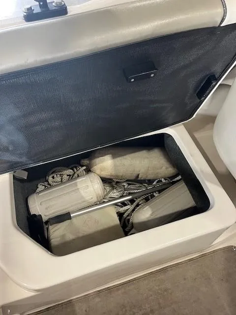 Slide: The Image of Storage compartment on a 2006 Sea Ray Sundeck 240 boat with ropes and equipment. - 27