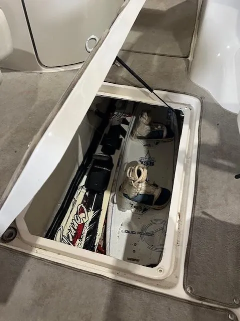 Slide: The Image of Storage compartment in 2006 Sea Ray Sundeck 240 with wakeboards and gear. - 28