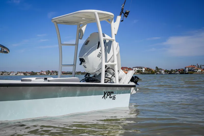 Slide: The Image of Custom XPC 16 boat on water, 2025 model, with scenic coastal background. - 10