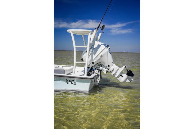 Slide: The Image of Custom XPC 16 boat in shallow water, showcasing sleek design, 2025 model. - 11