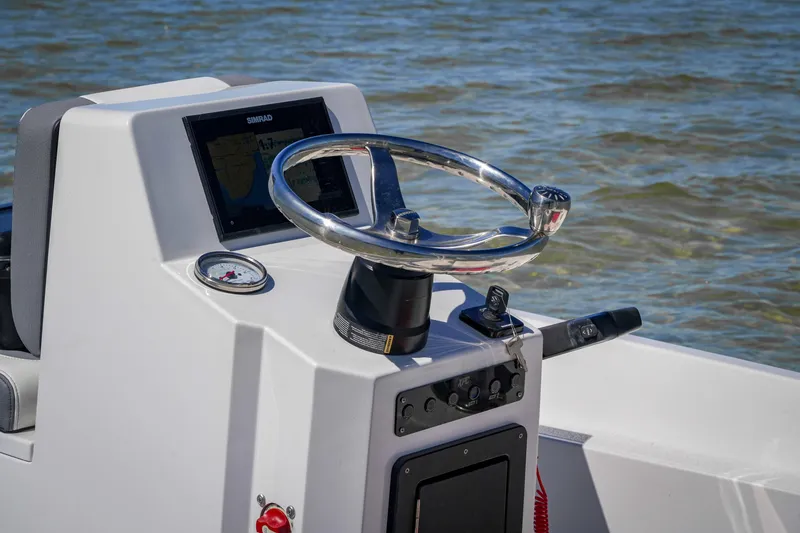 Slide: The Image of Steering console of 2025 Custom XPC 16 boat with navigation display on water. - 12