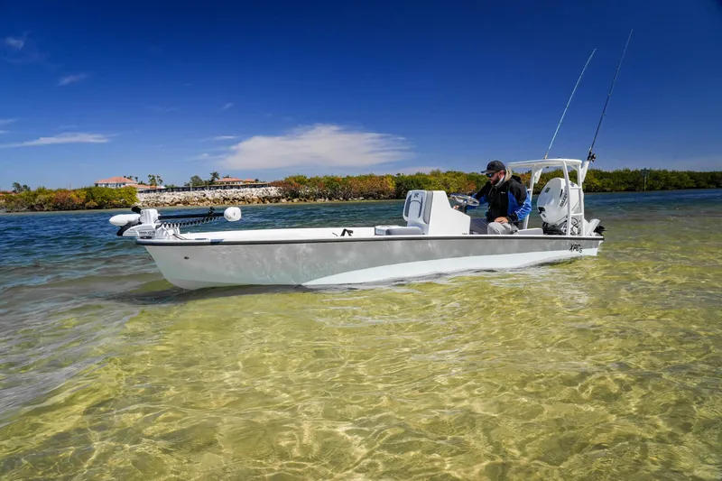 Slide: The Image of Custom XPC 16 boat in shallow water, 2025 model, with fishing gear and clear skies. - 17