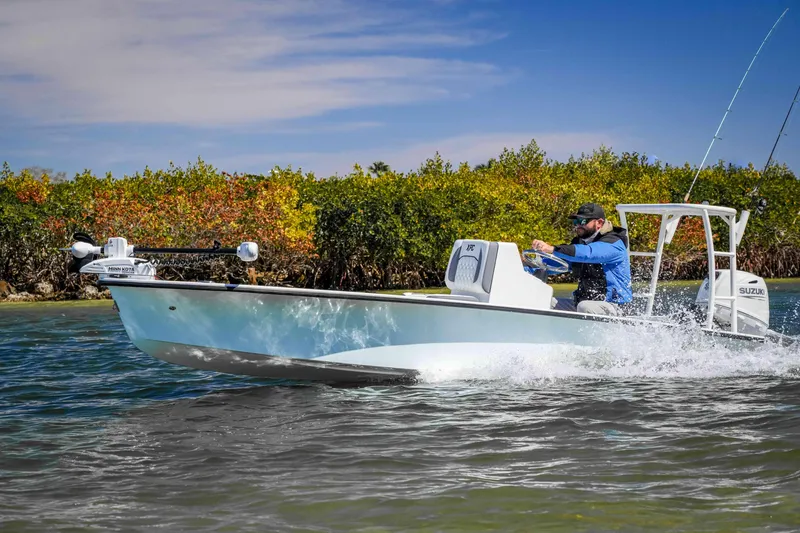 Slide: The Image of Custom XPC 16 boat cruising on water, 2025 model, with lush greenery in the background. - 18