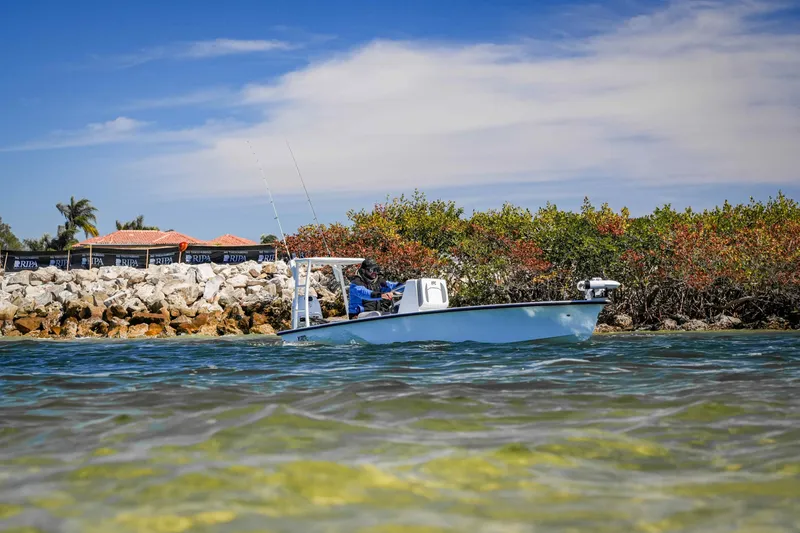 Slide: The Image of Custom XPC 16 boat cruising near rocky shoreline, 2025 model. - 20