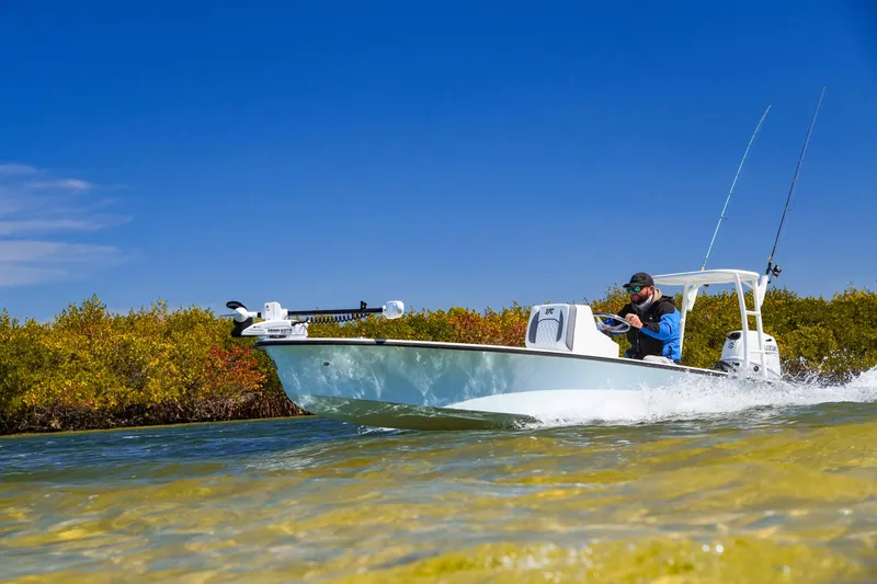 Slide: The Image of Custom XPC 16 boat cruising in clear waters, 2025 model, under a bright blue sky. - 22
