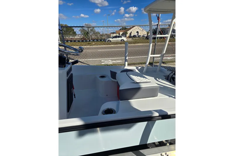 Slide: The Image of Custom XPC 16 boat interior, 2025 model, featuring seating and steering wheel under a clear blue sky. - 7