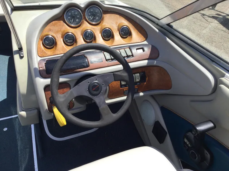 Slide: The Image of 1997 Maxum 2100 SR boat dashboard with steering wheel and instrument panel. - 10
