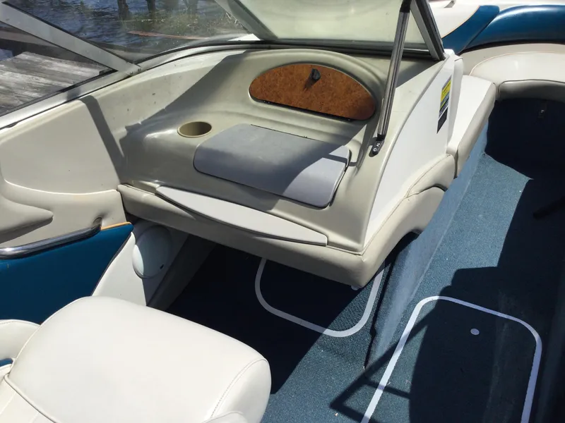 Slide: The Image of 1997 Maxum 2100 SR boat interior with white seating and blue carpet. - 11