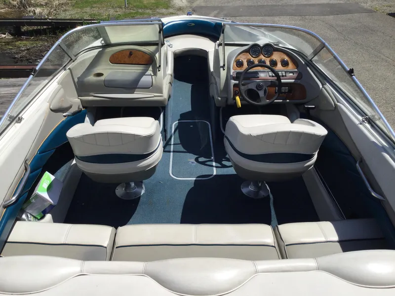 Slide: The Image of 1997 Maxum 2100 SR boat interior with seating and dashboard view. - 6