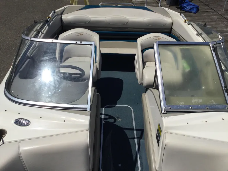 Slide: The Image of 1997 Maxum 2100 SR boat interior with beige seating and open windshield. - 7