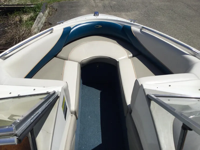 Slide: The Image of 1997 Maxum 2100 SR boat interior with blue and white seating. - 8