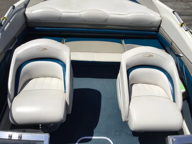 Slide: The Image of 1997 Maxum 2100 SR boat interior with white and blue seating. - 9