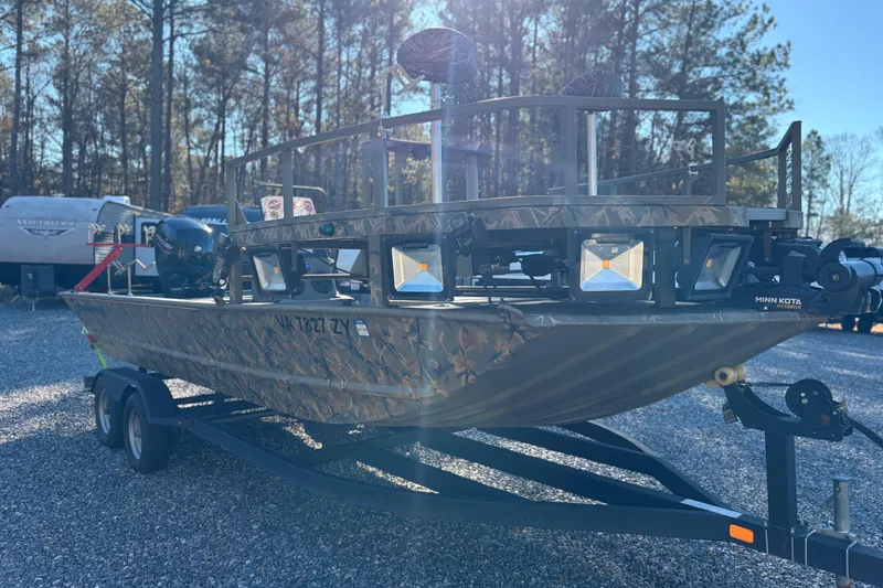Slide: The Image of 2020 Tracker Grizzly 2072 boat on trailer in wooded area. - 11