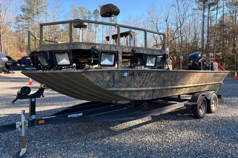 Slide: The Image of 2020 Tracker Grizzly 2072 boat on trailer, camo design, parked outdoors. - 12